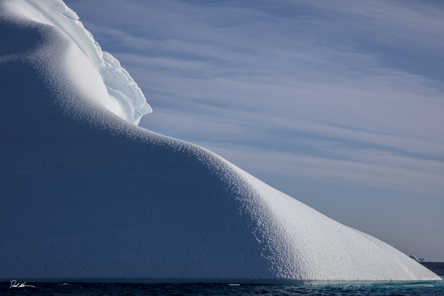 Large iceberg resembling sand dun in Antartica