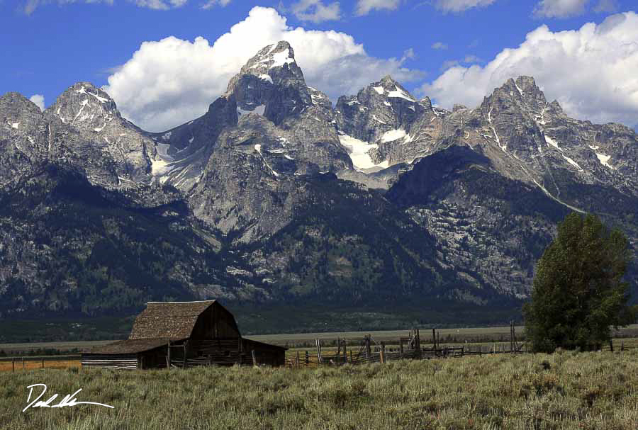 wooden barn beside mountains