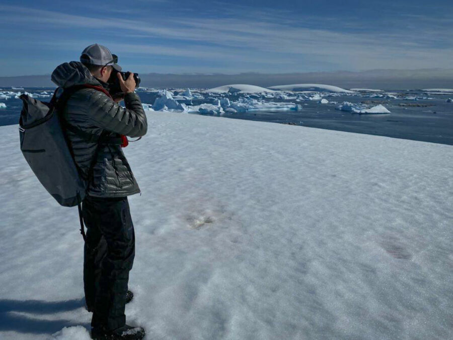 Image of photographer Derek Nielsen standing on the ground in Antarctica 