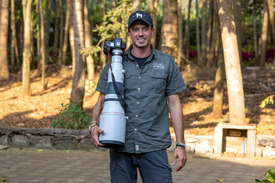 Photographer Derek Nielsen in Africa on safari holding a 600mm Canon lens