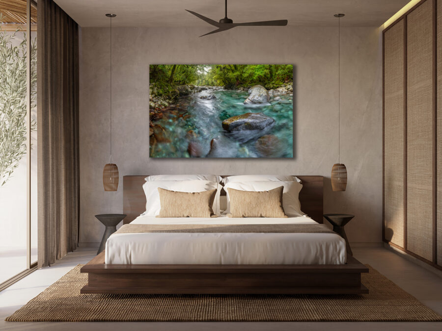 image of an unframed photograph of a river in New Zealand displayed above the bed in a luxury hotel room enhancing hospitality interior design