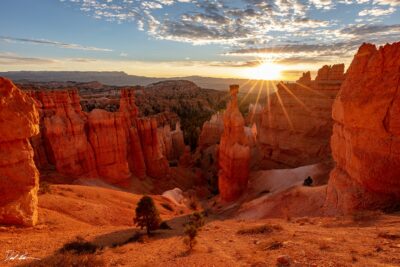 image of Bryce Canyon at sunrise with a deep red glow across the landscape