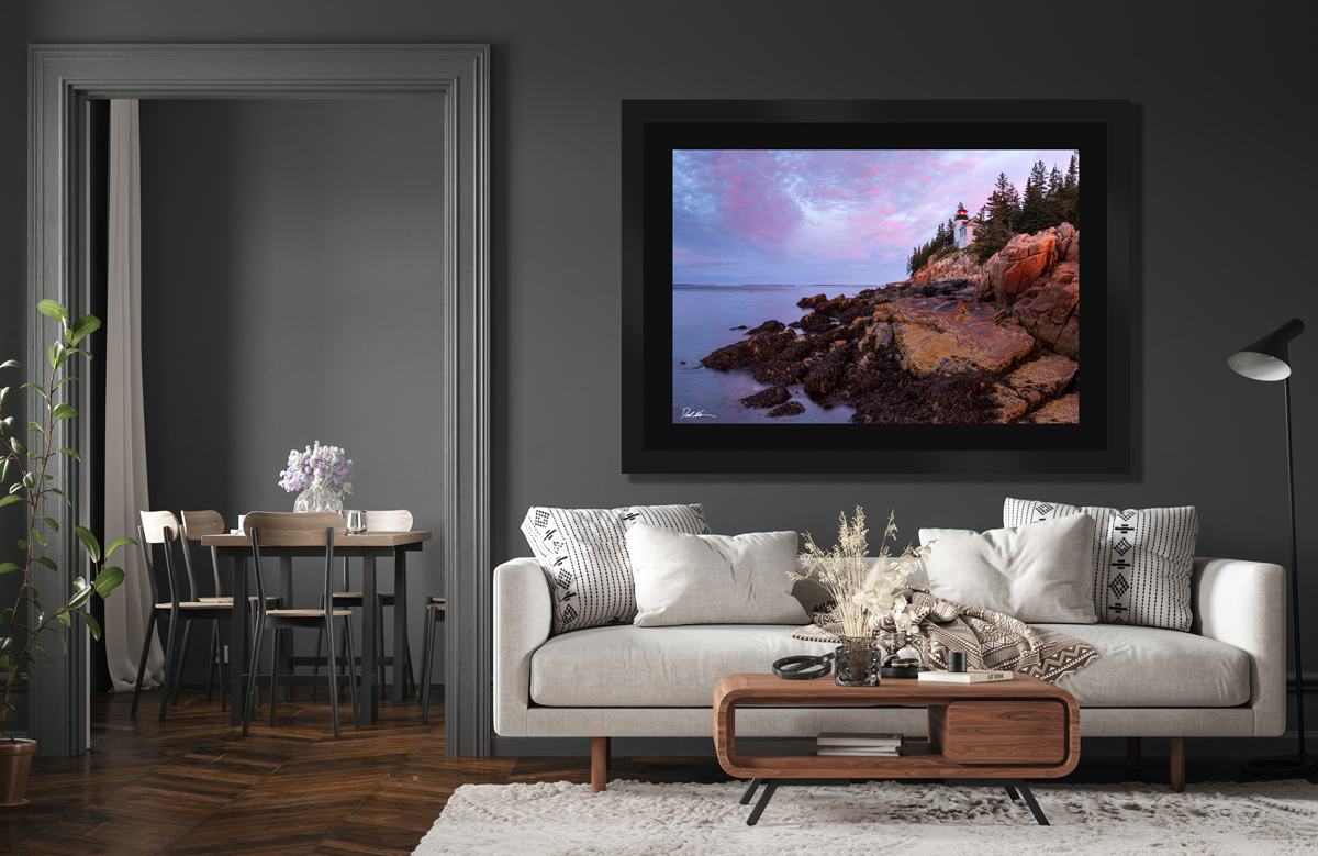 large framed fine art print of a lighthouse in Maine displayed in the living room of a modern home