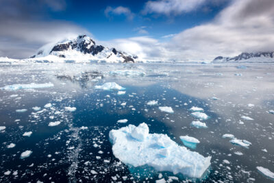 Floating icebergs and gagged peaks of Antarctica