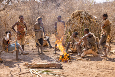 Hadzabe tribal members standing around fire