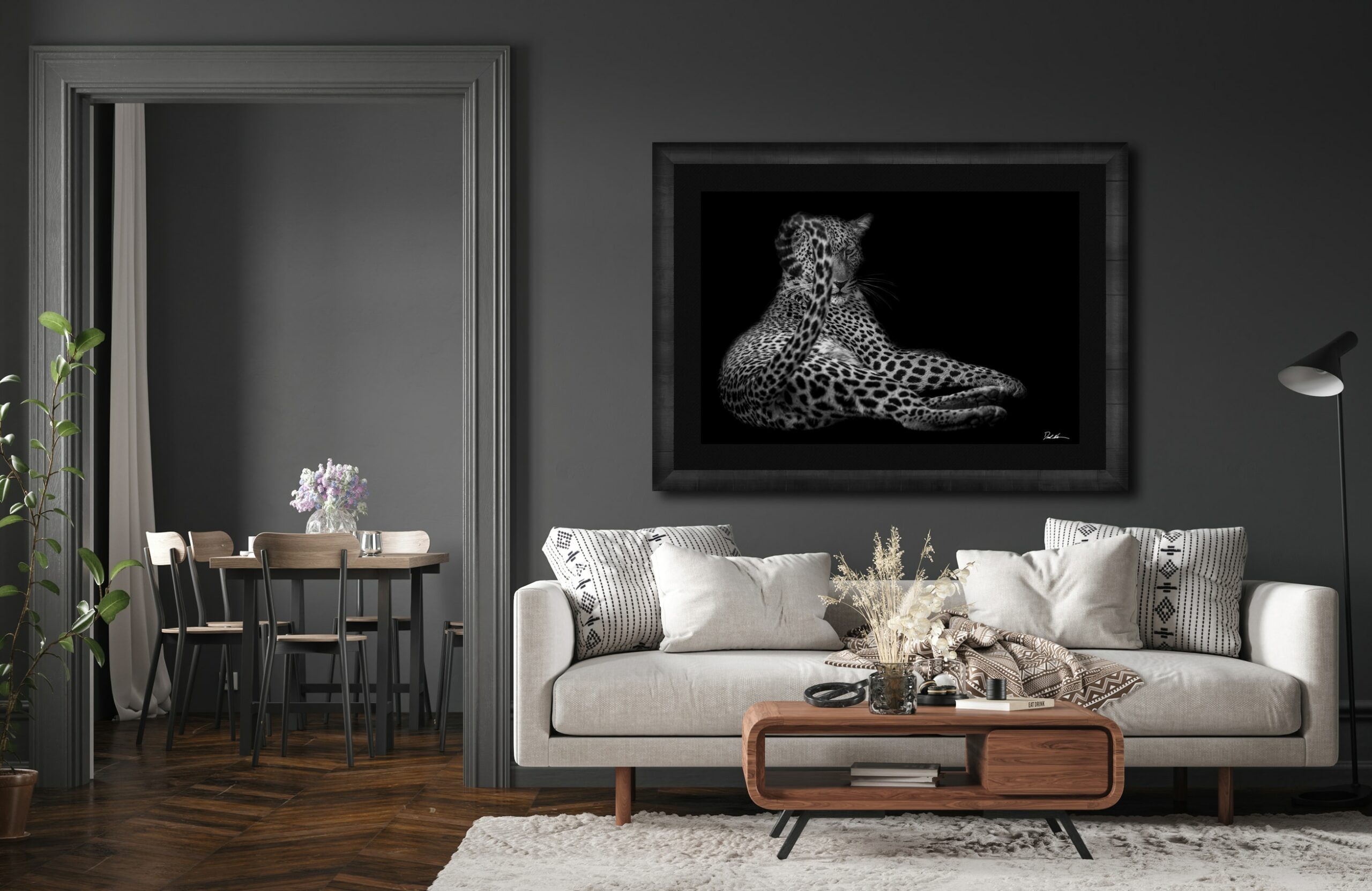 large framed fine art print of a leopard displayed above the couch in a modern luxury home