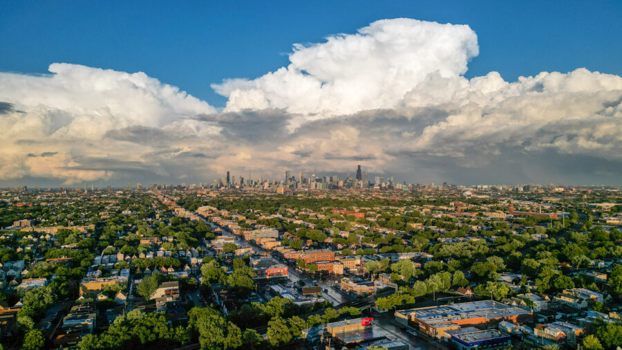 Areal photo of Chicago taken from a DJI Drone with big puffy clouds behind the city