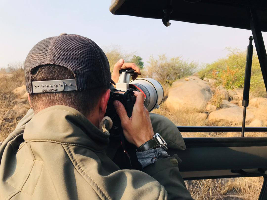 Image of photographer Derek Nielsen photographing a leopard in the Serengeti National Park