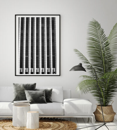 Large framed abstract black and white fine art print of the Standard Oil building in Chicago displayed in the living room of a modern home