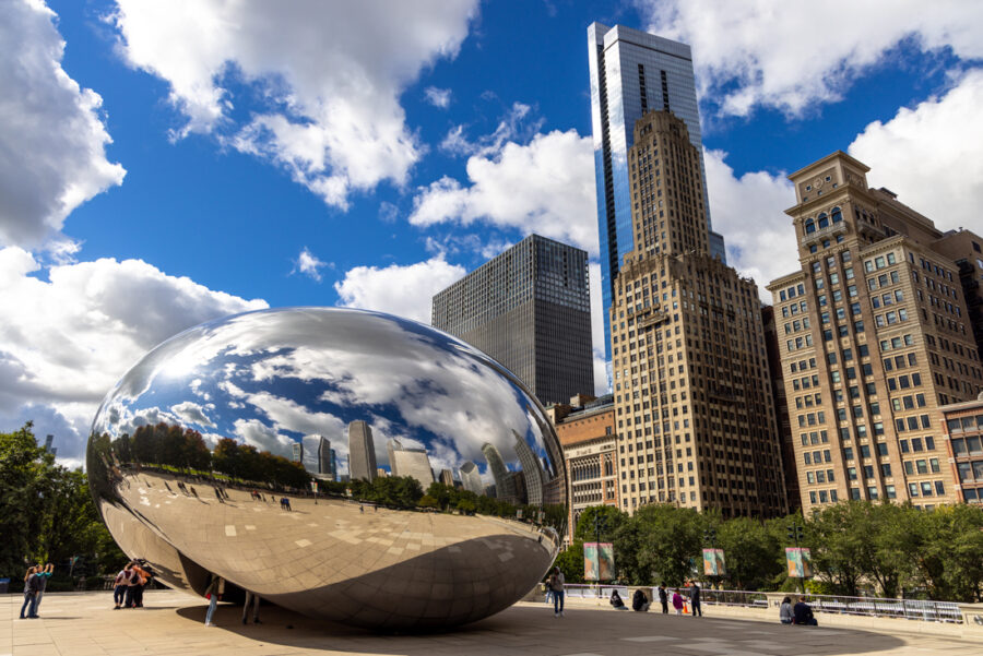 Image of The Bean in Chicago Millennium Park with blue skies and puffy white clouds