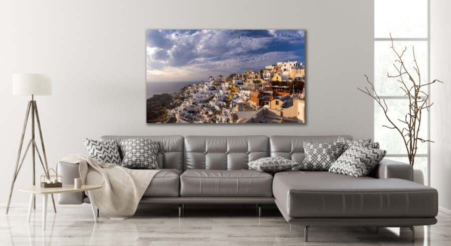Large unframed fine art photographic print of Oia in Santorini Greece displayed in the living room of a luxury home