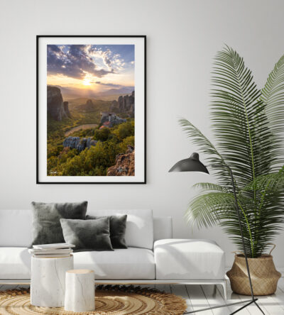 Large framed fine art print of Meteora in Greece displayed in the living room of a cozy home
