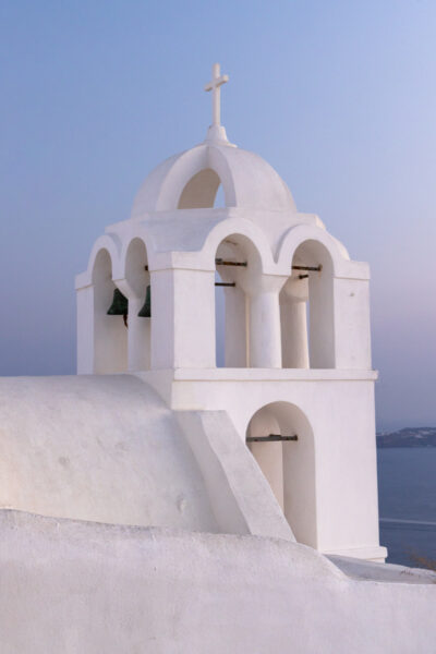 Image of a church bell tower in Santorini Greece post sunset
