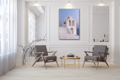 Large unframed lumachrome fine art print of a church in Santorini Greece displayed in the living room of a modern home