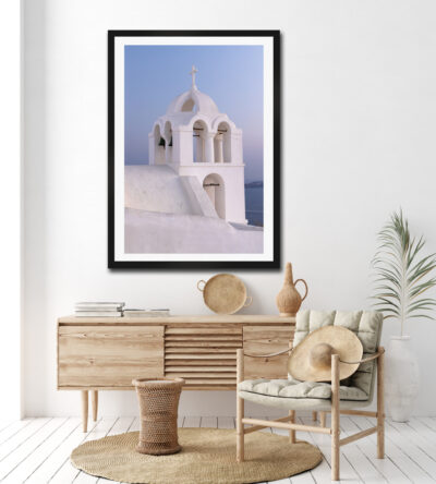 Framed fine art print of a church at sunrise in Santorini Greece displayed in the hallway of a clean modern home