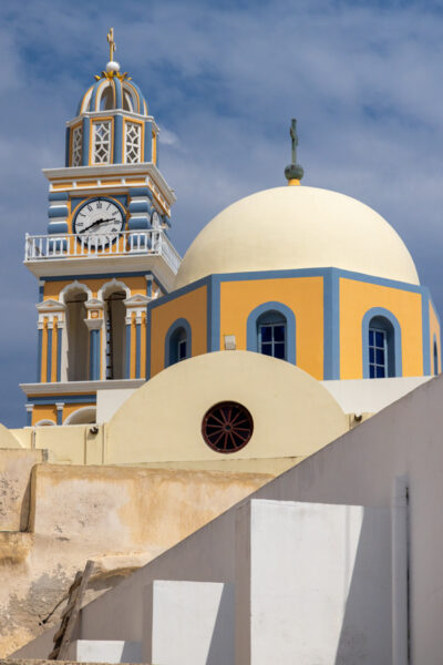 Image of an orthodox church in Santorini Greece with a decorated clock tower