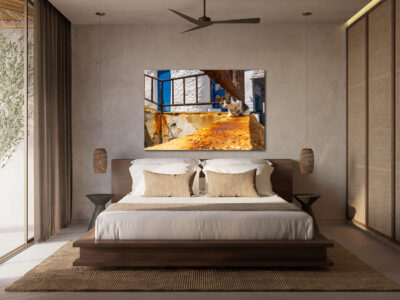 large unframed lumachrome fine art print of a cat in Greece displayed in the bedroom of a modern home