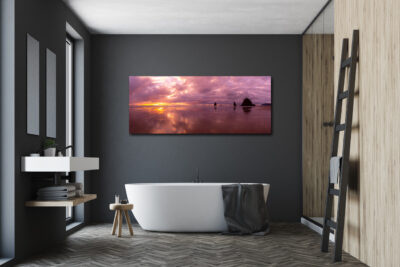 Large panoramic image of Canon Beach in Oregon displayed in a bathroom of a modern luxury home