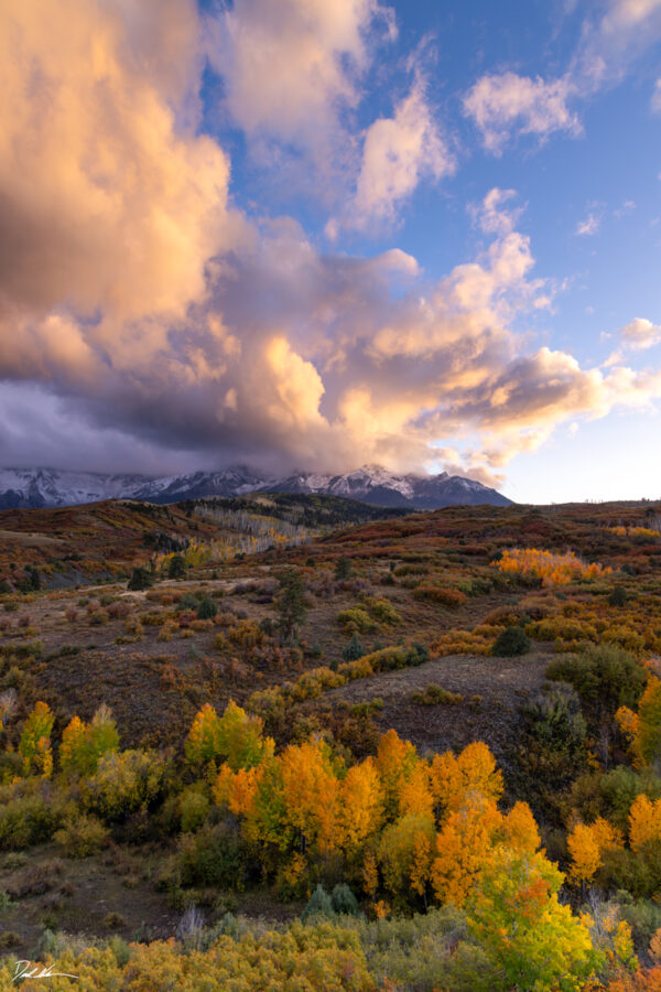 vertical image of the Dallas Divide in Colorado with a beautiful sunset during fall
