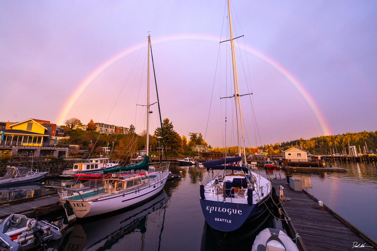 image of a large rainbow over Friday Harbor, Washington at sunrise