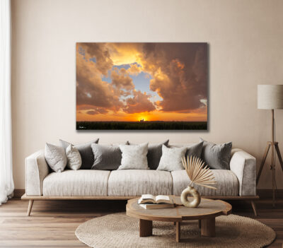 large unframed image of a farm taken at sunset displayed in the living room of a luxury home
