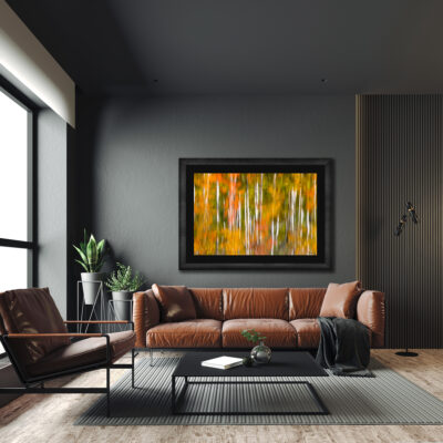 large framed fine art print of aspen trees reflecting off a lake displayed in the living room of a modern home