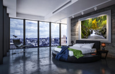 Large framed fine art print of a waterfall in Sol Duc Olympic National Park displayed above the bed in a luxury urban apartment