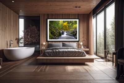 Large framed image of a waterfall in Sol Duc Olympic National Park displayed above the bed of a luxury hotel