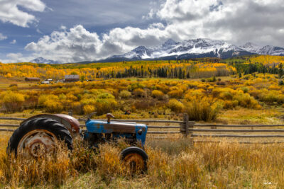 image of a tractor in Telluride Colorado high up in the mountains on a ranch during fall