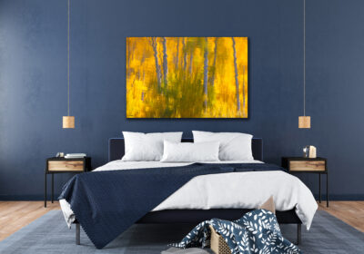 large unframed fine art print of aspen trees reflecting off a lake displayed in a modern bedroom