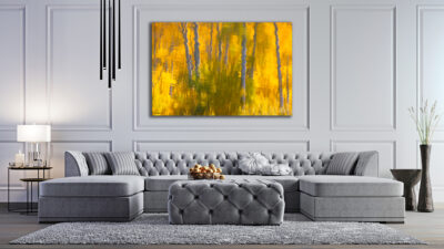 large unframed fine art image of aspen trees reflecting off a lake displayed in a luxury home
