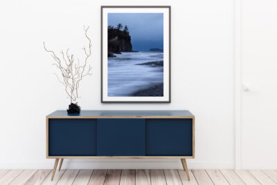 Large framed fine art print of Ruby Beach in Olympic National Park displayed in the hallway of a luxury home