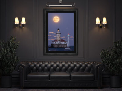 large fine art framed print of a super moon rising behind Chicago's Navy Pier lighthouse with a sailboat crossing in front displayed in the lounge of a luxury hotel