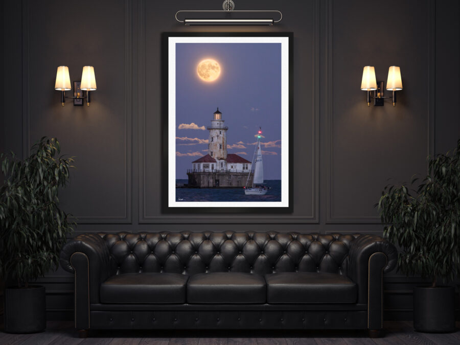 Large framed fine art print of a sailboat infront of a lighthouse under a full moon in Chicago