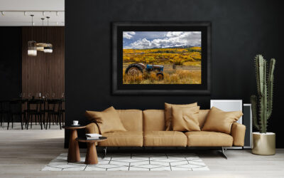 large framed fine art print of a tractor in Telluride Colorado during fall displayed in the living room of a modern luxury home