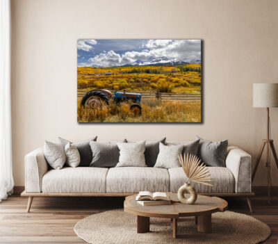 Large unframed fine art image of a tractor in Telluride, Colorado displayed in the living room of a modern home