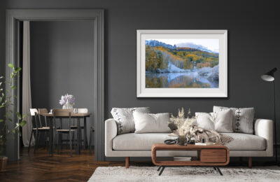 Large framed fine art print of a wintery fall scene displayed above the couch of a luxury home