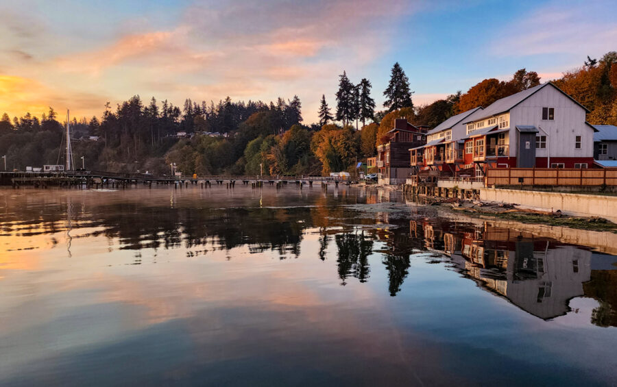 Image of the Boatyard Inn in Langley Washington during sunrise over the water