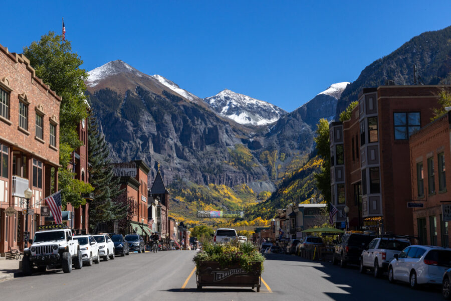 image of downtown Telluride Colorado with fall colors and snow on the mountains