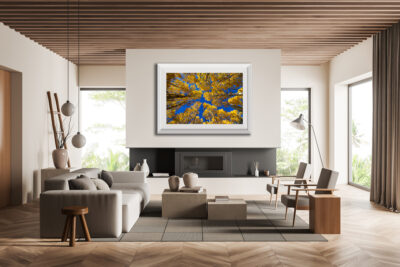 Large framed fine art print of aspen trees in Telluride Colorado displayed above the fire place of a modern home