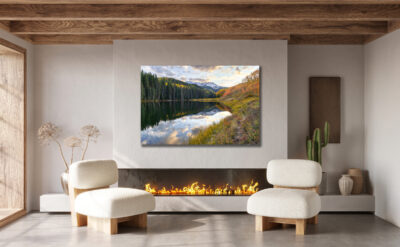 Large fine art print of a fall mountain scene displayed in the living room of a modern southwest home