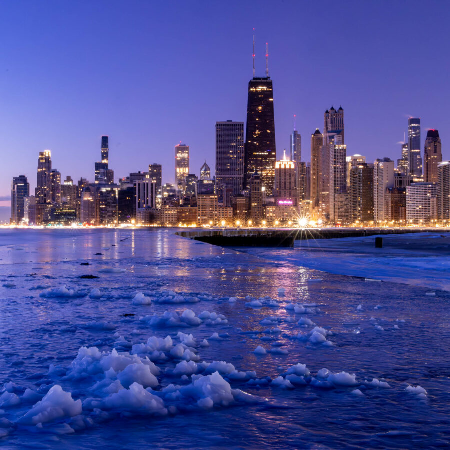 Beautiful image of Chicago taken during blue hour with ice in the foreground. 