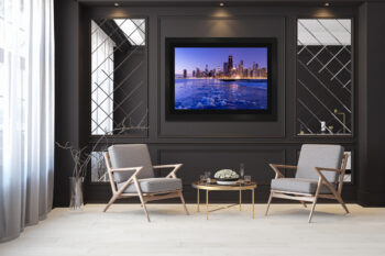 Large framed fine art print of Chicago at sunrise with ice on the ground displayed in the living room of a modern luxury home