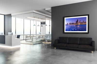 Large framed fine art print of Chicago during a winter sunrise displayed in an office setting
