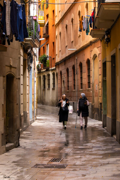 Fine art image of two Spanish women walking through the narrow streets of Barcelona Spain