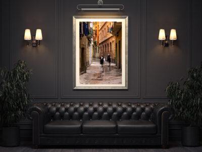 Beautiful framed fine art print of two Spanish women walking down the narrow streets of Barcelona displayed in the waiting are of a luxury restaurant