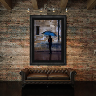 Very large framed fine art print of a woman holding an umbrella displayed in the lobby of a fancy restaurant