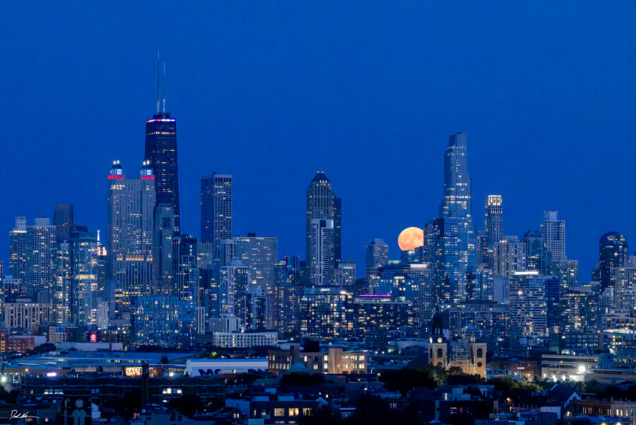 photograph of a full moon rising over Chicago at dusk