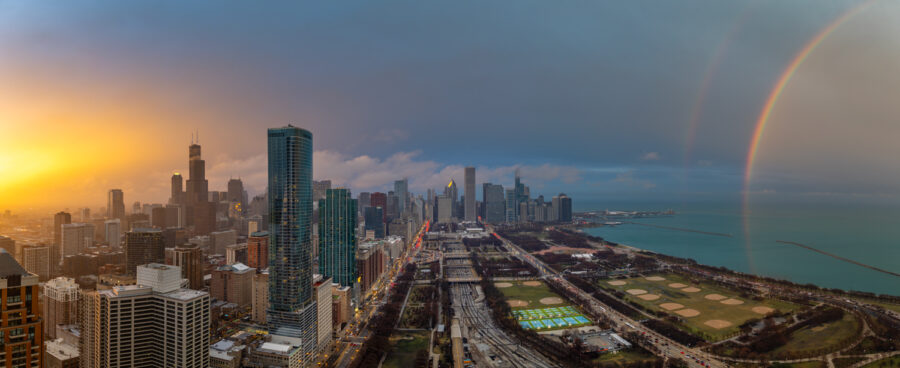 panoramic photo of Chicago from high above the city at sunset with vivid colors and a rainbow over the lake