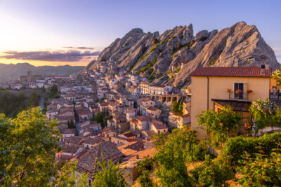 Pietrapertosa Italy at sunset with soft light covering the mountains and town